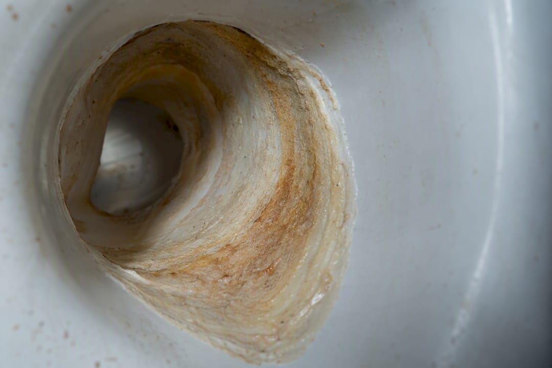 Mineral scale buildup inside toilet trapway pipe