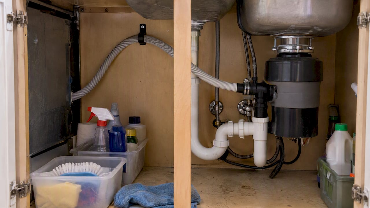 Dishwasher drain hose secured in high loop
